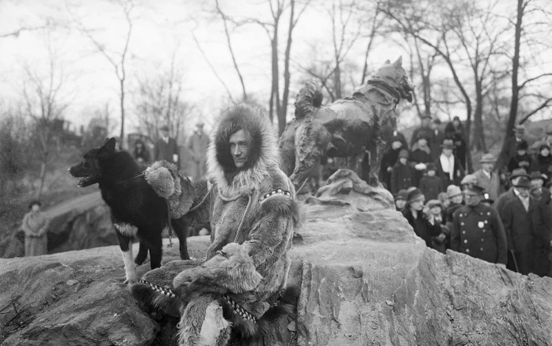 a black and white photograph of Musher Gunnar Kasson and his dog Balto are seen in close-up at the unveiling of a statue in Central Park New York to honor Balto